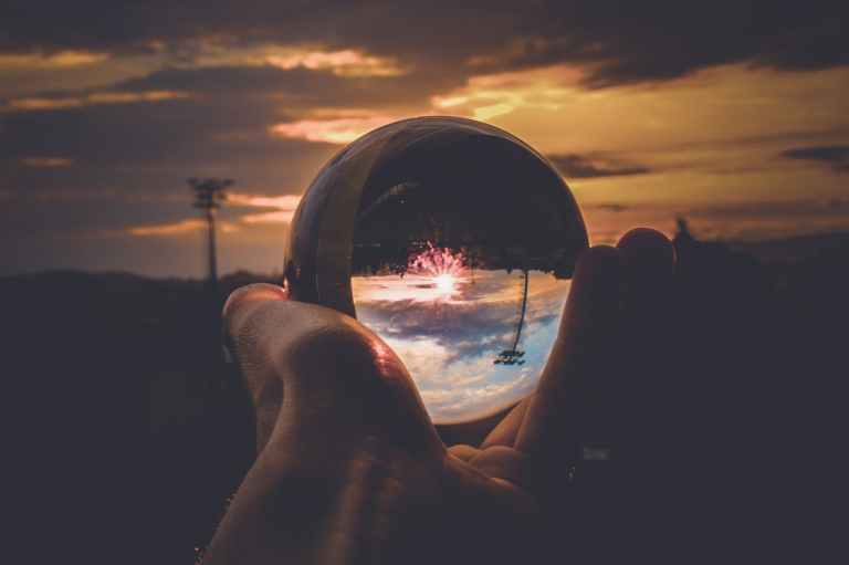 person holding clear glass ball
